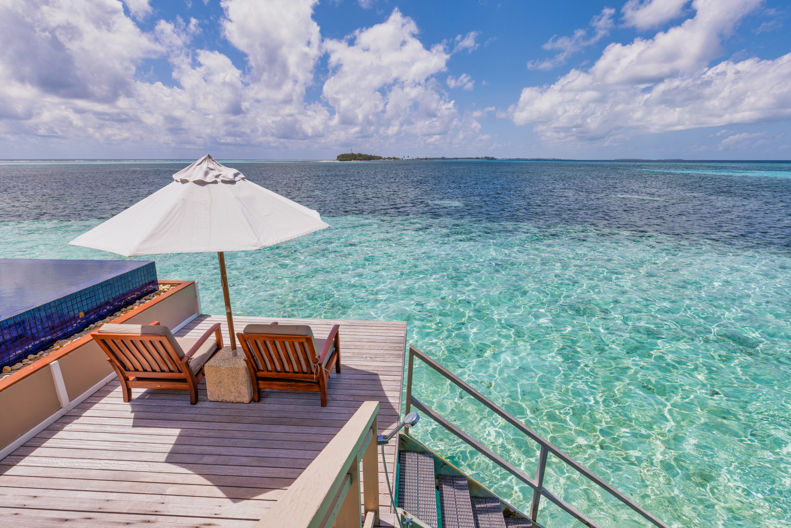 deck-chairs-umbrellas-maldives-resort-with-infinity-pool-beach-sea-sky-view-luxury-terrace