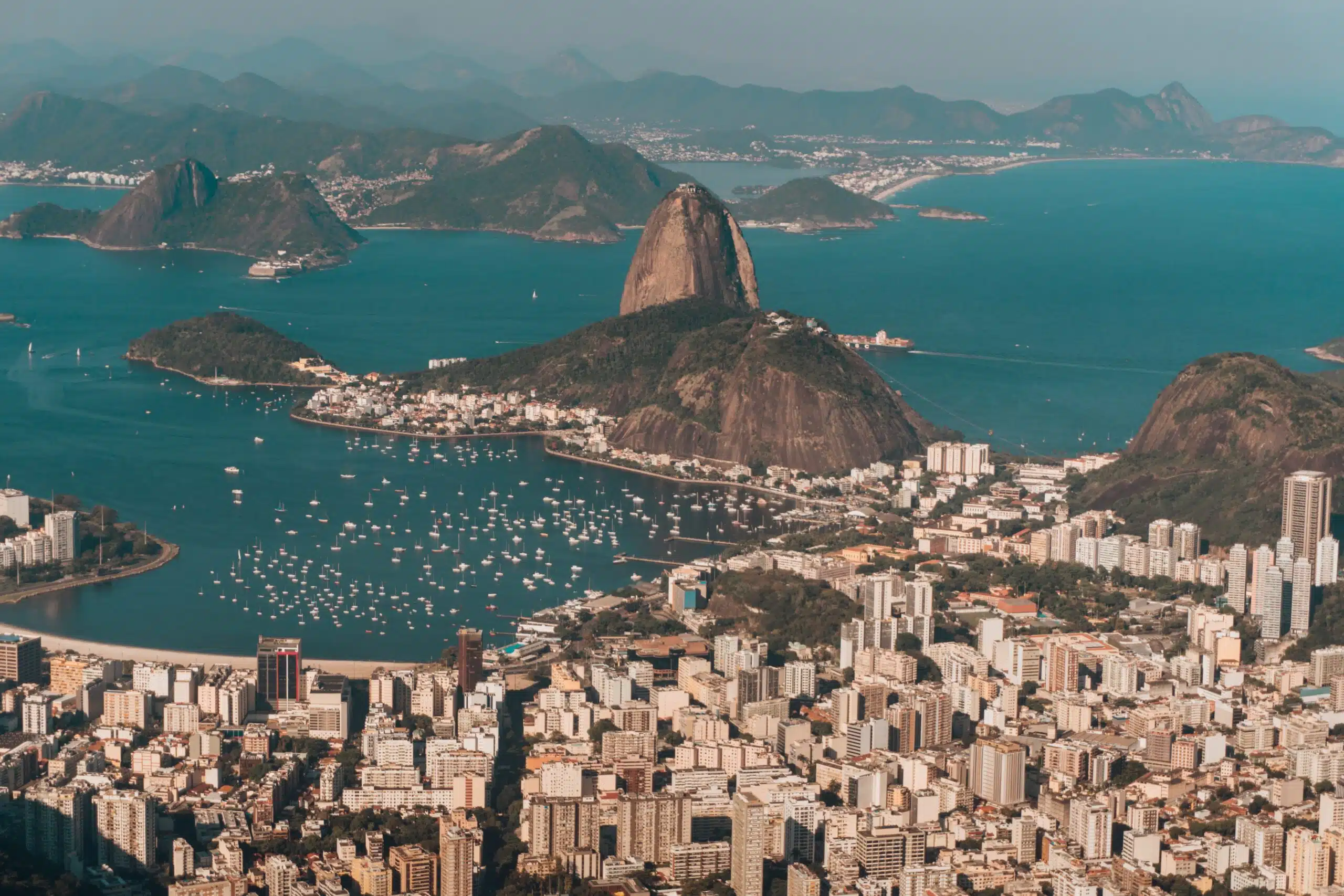 Aerial photo of Rio de Janeiro surrounded by the sea and hills under the sunlight in Brazil