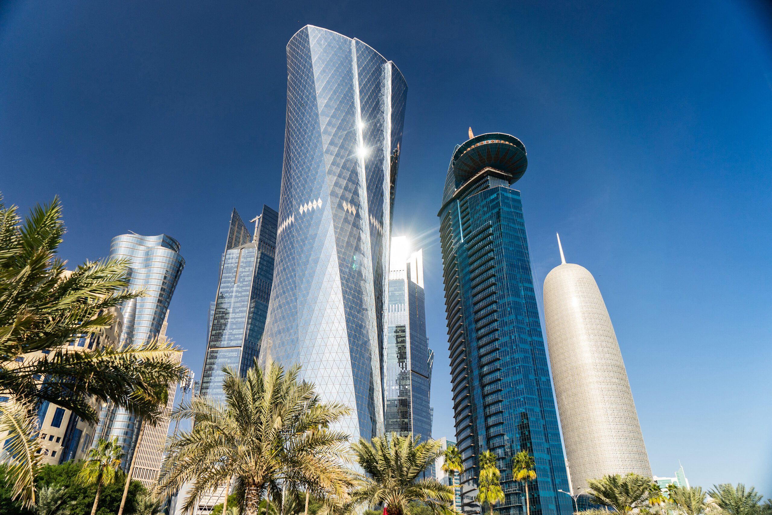 Modern city center with Towers and skyscrapers on sunny sky background. Doha, Qatar 2020