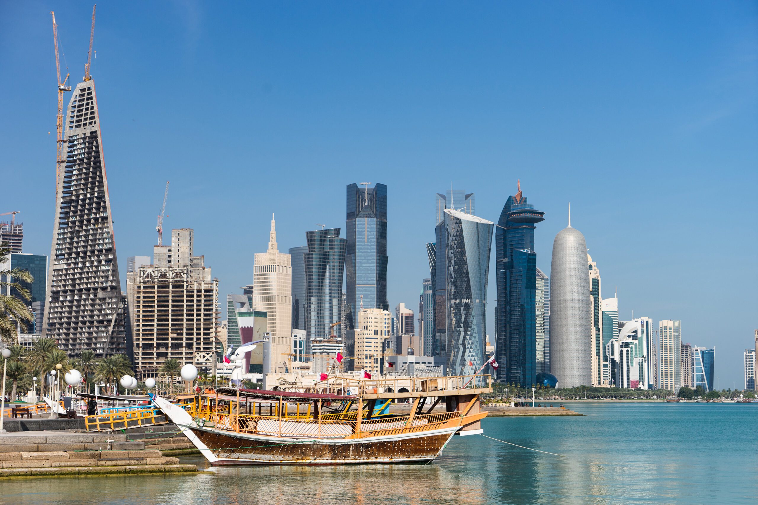 Skyscrapers in the city center with water and boat foreground of Doha, Qatar 2020.